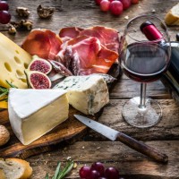 appetizer: red wine, cheese and cured ham on rustic wooden table - food stock pictures, royalty-free photos & images