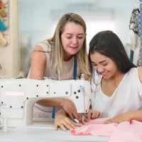 apprentice seamstress learning to sew at an atelier - fashion stock pictures, royalty-free photos & images