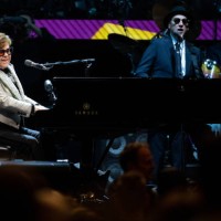 April 2023, Bavaria, Munich: Singer and pianist Elton John sits on stage at the Olympiahalle during a concert as part of his "Farewell Yellow Brick...