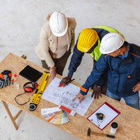 architect, business manager and civil engineer meeting project at planning desk - home decoration stockfoto's en -beelden