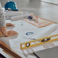 architect, hands and planning on blueprint for construction or preparation for building on office desk. hand of engineer in architectural design for project, floor plan or industrial layout strategy - home decoration stock pi