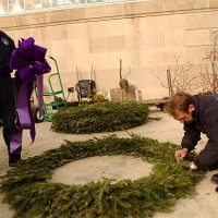 Architect of the Capitol employees, Ken Puza, left, and Brian Griffin, assemble a wreath to be hung as one of many on the front of the Botanic...