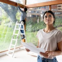 architect renovating a house and holding designs at the construction site - home decoration stock pictures, royalty-free photos & images