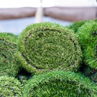 artificial synthetic grass rolled up in a store on display for sale - garden decoration stock pictures, royalty-free photos & images