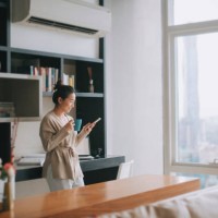 asian chinese beautiful woman enjoying her afternoon tea at living room looking outside window relax leaning on table - home decoration stock pictures, royalty-free photos & images