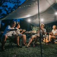 asian chinese family with 2 teenager offspring enjoying dinner at camping tent late evening - home decoration stock pictures, royalty-free photos & images