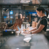 asian chinese female barista using laptop while enjoying dinner at coffee shop bar counter - food stock pictures, royalty-free photos & images