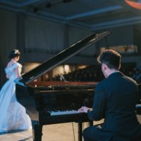 asian chinese pianist playing grand piano with female opera singer performing solo on stage - concert stock pictures, royalty-free photos & images