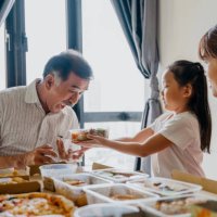 asian family eating take away food at home - junk food stock pictures, royalty-free photos & images