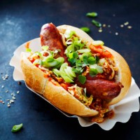 asian hot dog, fried sausage, spicy chinese cabbage, hot chili sauce, spring onions, cress, bun - junk food stock pictures, royalty-free photos & images