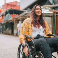 asian indian beautiful woman with disability using wheelchair exploring downtown district in kuala lumpur - travel stock pictures, royalty-free photos & images