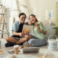 asian lover marry couple sit relax choosing new colour after test paint new colour new apartment home relocation moving in new house,asia husband wife sit using laptop searching ideas for home decorating sit on floor daytime 