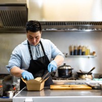 asian male cook making food parcel for delivery - junk food stock pictures, royalty-free photos & images