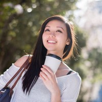 asian woman drinking coffee on the go - junk food stock pictures, royalty-free photos & images