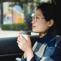 asian woman enjoying coffee in a reusable cup-1 - junk food stock pictures, royalty-free photos & images