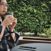 asian woman enjoying coffee using reusable cup - junk food stock pictures, royalty-free photos & images
