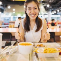 asian woman hand hold fork and spoon ready to enjoy fried chicken for eat korean food at airport - junk food stock pictures, royalty-free photos & images
