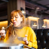 asian woman having lunch eating hot pot at restaurant - food stock pictures, royalty-free photos & images