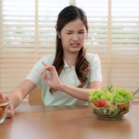 asian woman refusing to eat fried chicken for good health. - junk food stock pictures, royalty-free photos & images