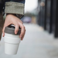 asian woman walking with coffee in a reusable cup - junk food stock pictures, royalty-free photos & images