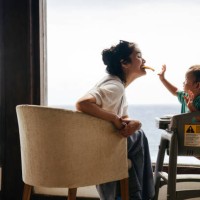 asian woman with her son sitting on the chair eating pizza - food stock pictures, royalty-free photos & images