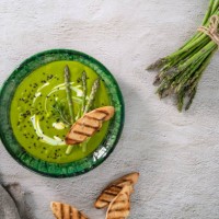 asparagus soup plate with ingredients and bread toasts on white cement - food stock pictures, royalty-free photos & images