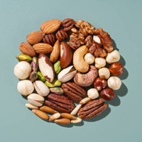assorted nuts organized in circle on green background - food stockfoto's en -beelden