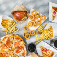 assorted take out food such as pizza, french fries, onion rings, burger and cola. - junk food stock pictures, royalty-free photos & images