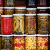 assortment of glass jars filled with pickled vegetables - food stock pictures, royalty-free photos & images