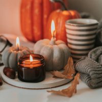 atmospheric candles shape of pumpkin, gray sweater, autumn decor on table. cozy autumn lifestyle, hygge concept. still life. - home decoration stock pictures, royalty-free photos & images