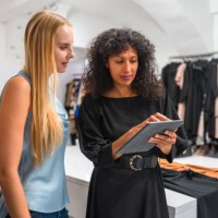 attractive business owner with female client - fashion stock pictures, royalty-free photos & images