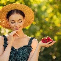 attractive girl with strawberries - food stock pictures, royalty-free photos & images