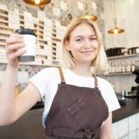 attractive smiling bartender making beverage in coffee shop - junk food stock pictures, royalty-free photos & images