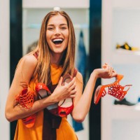 attractive woman in the shoe store holding a pile of new shoes - fashion stock pictures, royalty-free photos & images