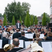 audience listening to a free outdoor concert of the local orchestra - concert stock pictures, royalty-free photos & images