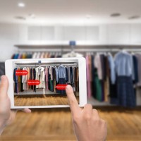 augmented reality marketing concept. hand holding digital tablet smart phone use ar application to check special sale price in retail fashion shop mall - fashion stock pictures, royalty-free photos & images