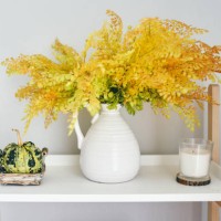 autumn home decor with decorative small pumpkins, flowers in a white vase and candles - home decoration stock pictures, royalty-free photos & images