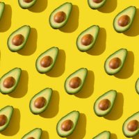 avocado halves pattern with hard shadow and trendy lighting on yellow background - food stock pictures, royalty-free photos & images