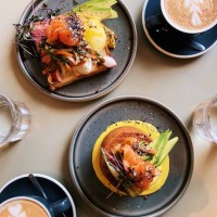 avocado toast with poached eggs and salmon and pancakes with avocado and salmon, directly above view - food stock pictures, royalty-free photos & images