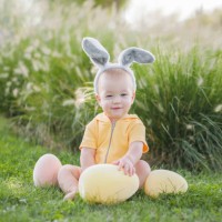 baby 10 months old with easter eggs and bunny ears. child is hunting for easter eggs in garden. - garden decoration stock pictures, royalty-free photos & images