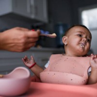 baby sitting in highchair refusing to eat - food stock pictures, royalty-free photos & images