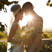 back lit bride and groom touching foreheads at wedding altar - garden decoration stockfoto's en -beelden