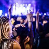 back view of carefree woman dancing on music concert by night. - concert stock pictures, royalty-free photos & images
