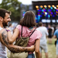 back view of happy embraced couple on music concert. - concert stock pictures, royalty-free photos & images