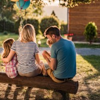 back view of relaxed family on a bench in the backyard. - garden decoration stock pictures, royalty-free photos & images