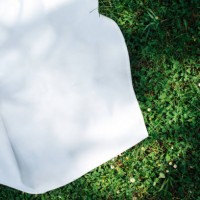 background with a white blanket on the grass. picnic. empty space for design. mockup for food and drinks. - garden decoration stock pictures, royalty-free photos & images
