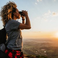 backpacker woman using binoculars - travel stock pictures, royalty-free photos & images