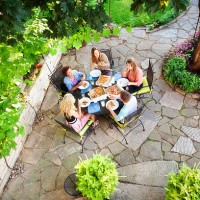 backyard patio, landscaping and garden with teenagers enjoying pizza - junk food stock pictures, royalty-free photos & images