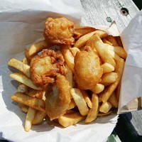 Bag of deep fried oysters and chips, a meal considered a local delicacy and available from many take-away outlets throughout New Zealand is seen on...