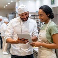 baker training a new employee at the bakery - food stock pictures, royalty-free photos & images